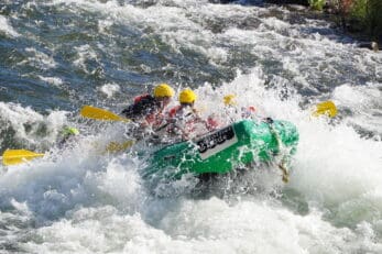 Rafters navigating challenging rapids on the South Fork river, highlighting the excitement of whitewater adventures and the importance of river conservation efforts at Mother Lode River Center.